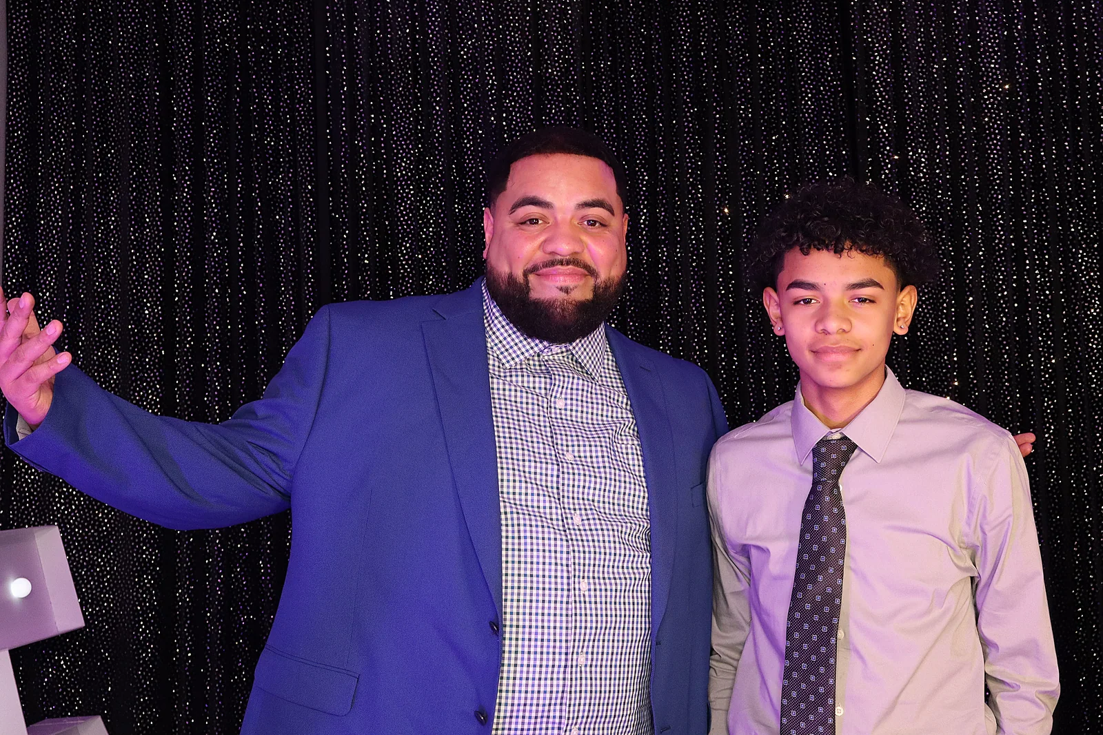 Father and son posing together at Jayla’s quinceañera by Images & Creations