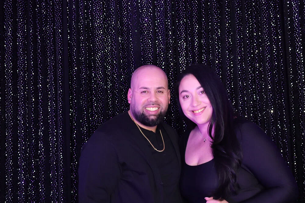 Two guests posing together in Jayla’s quinceañera booth by Images & Creations