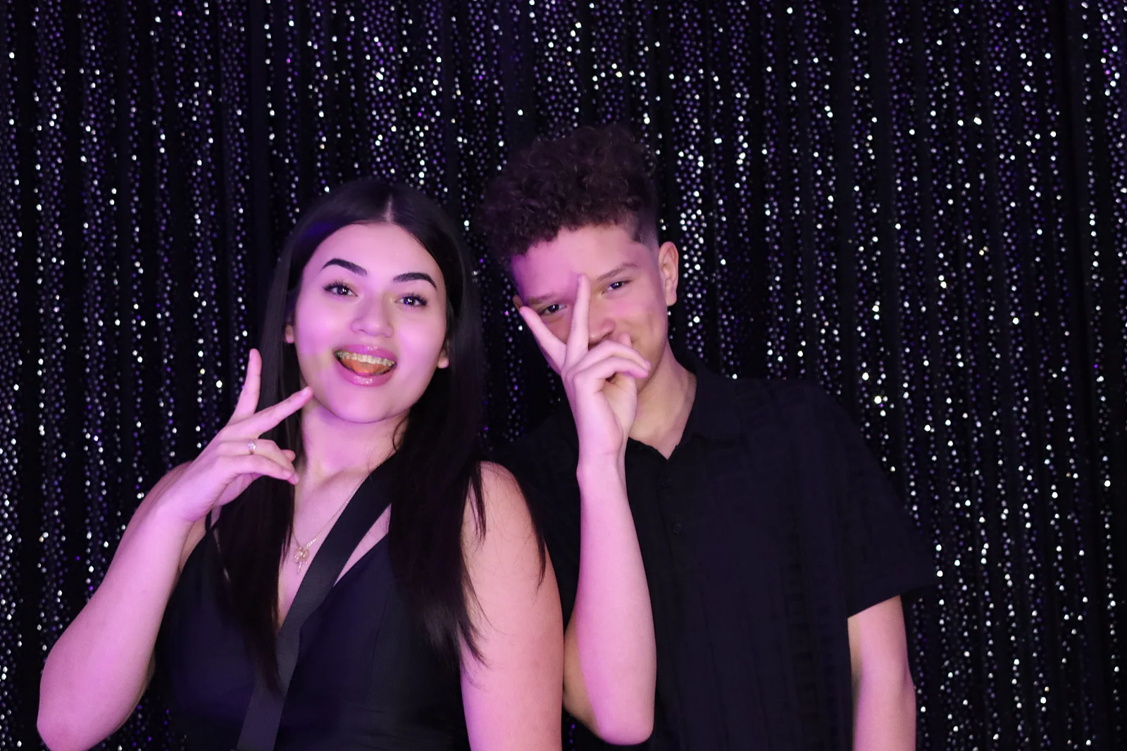 Young guests sharing a playful photo booth moment at a quinceañera by Images & Creations