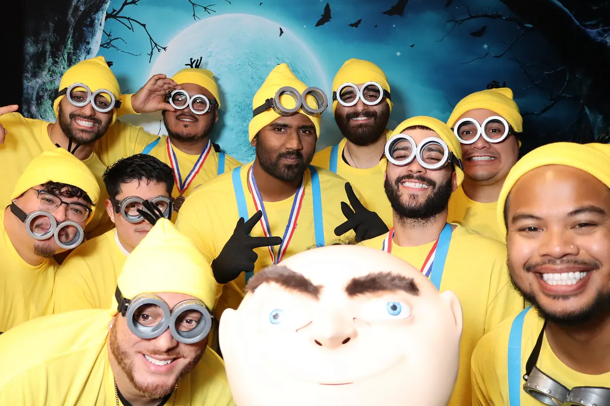 Large costumed group photographed in a dramatic themed scene