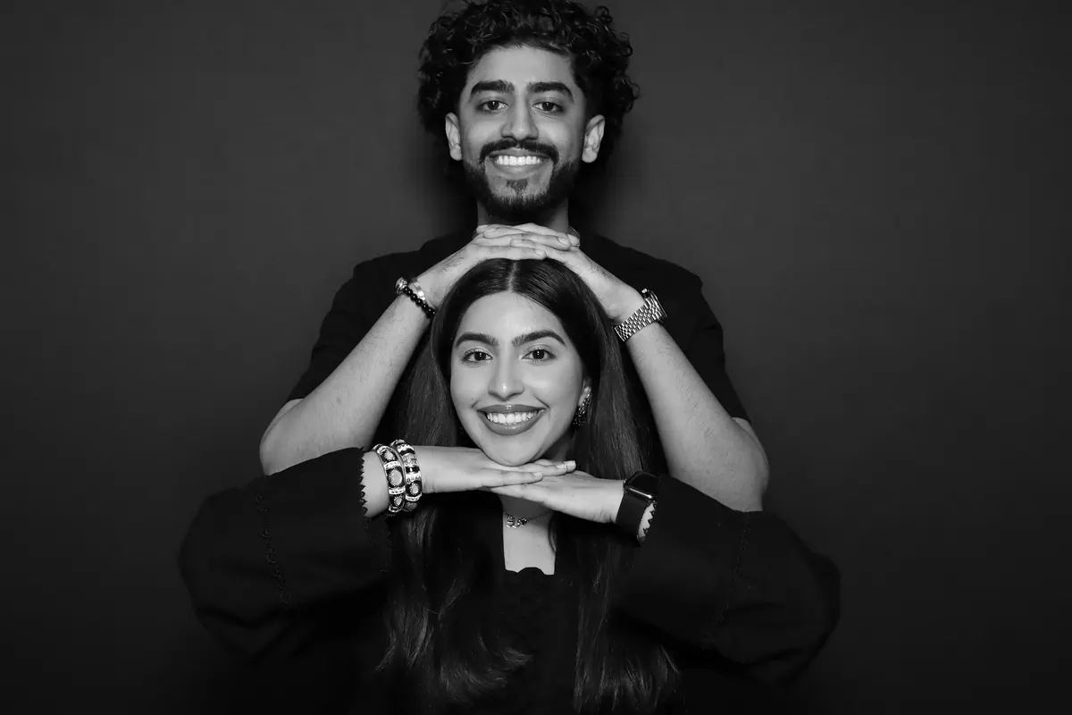 Guests posing for a polished black-and-white Glam portrait