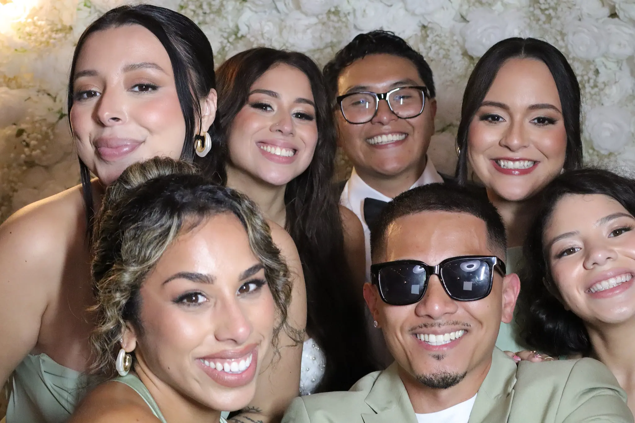 Wedding party gathered for a bright celebratory portrait by Images & Creations