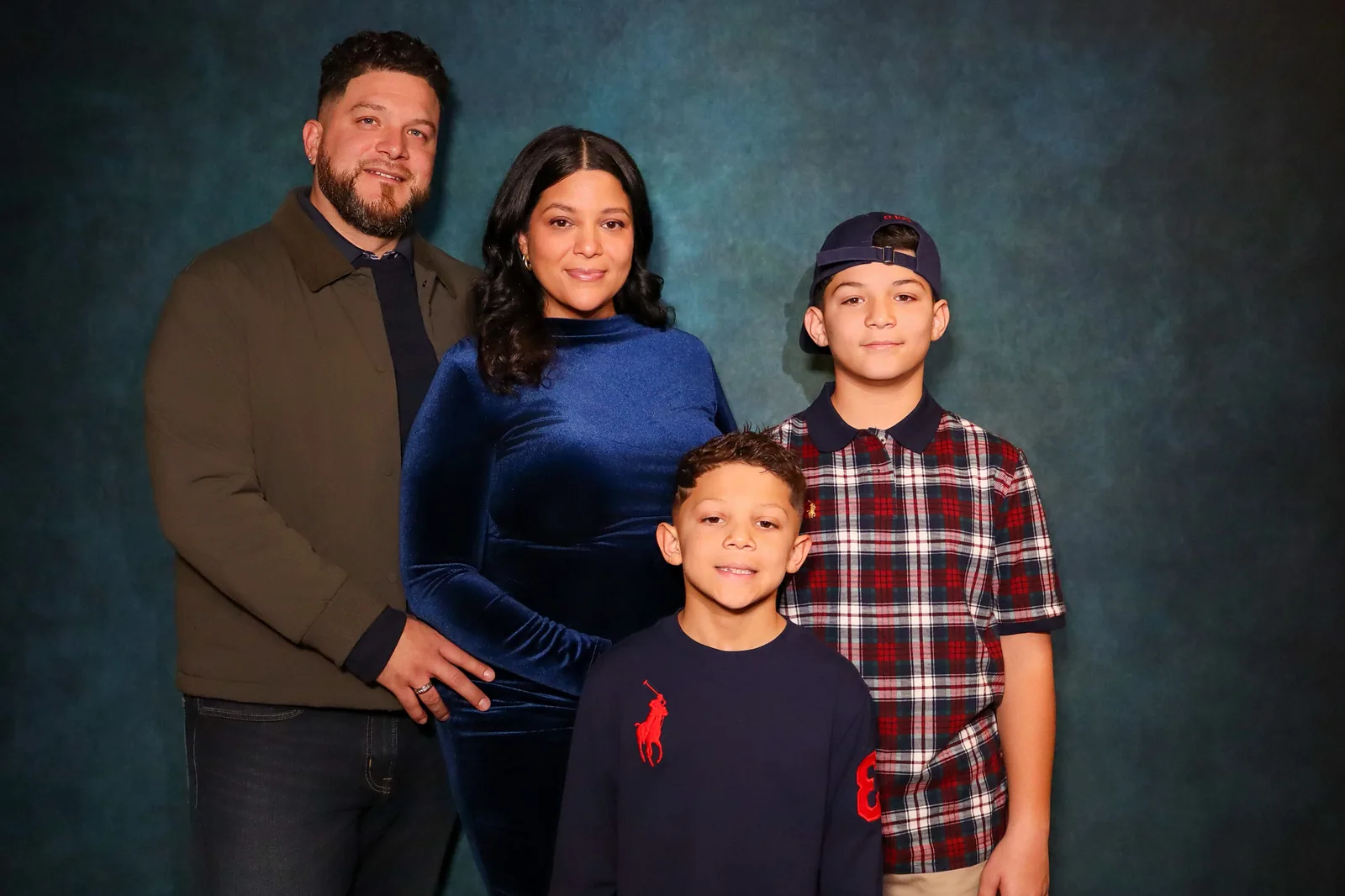 Janelli, Chris, and their two boys in the original baby shower portrait before AI styling