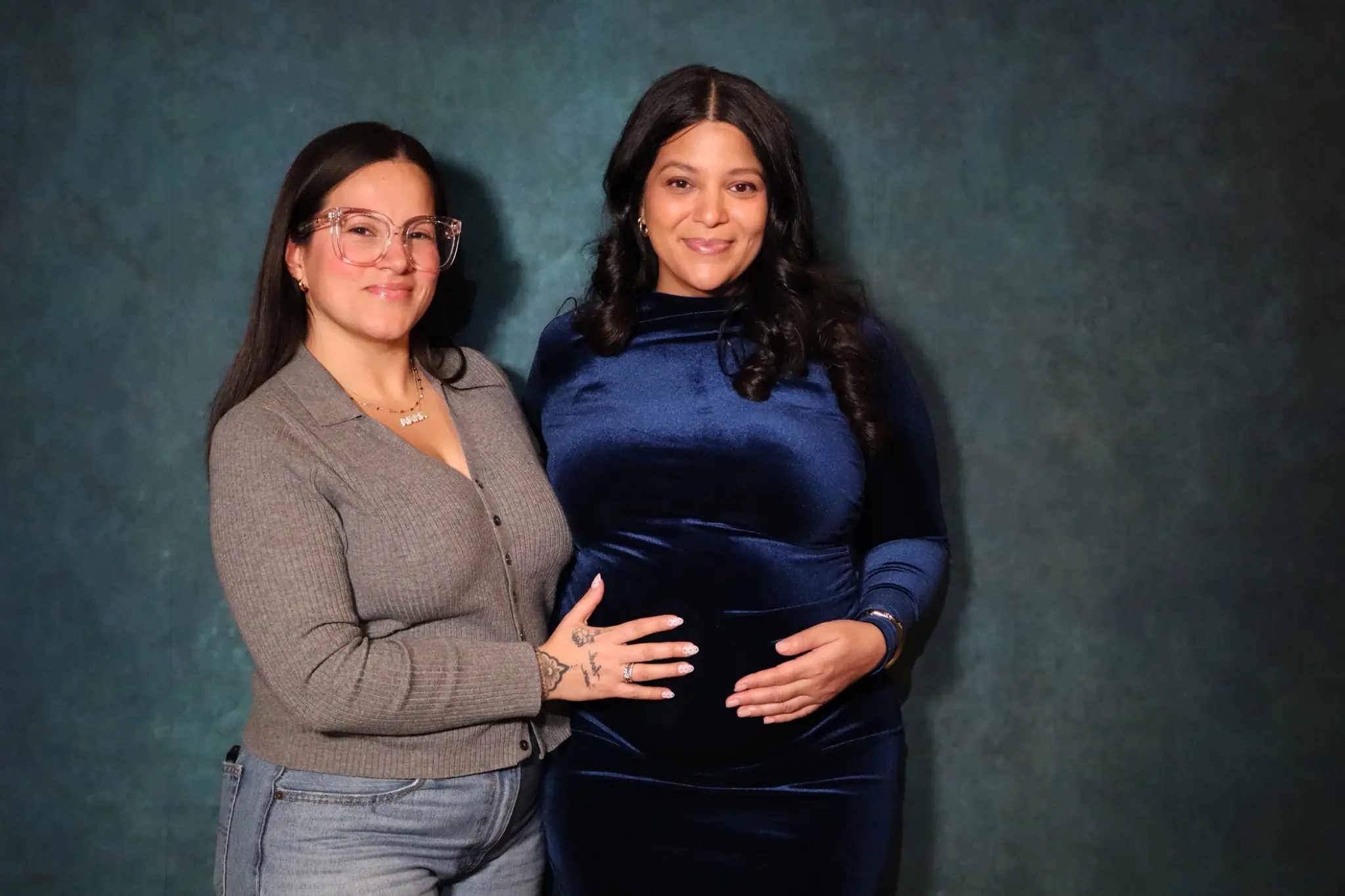 Two guests posing for a polished baby shower portrait by Images & Creations