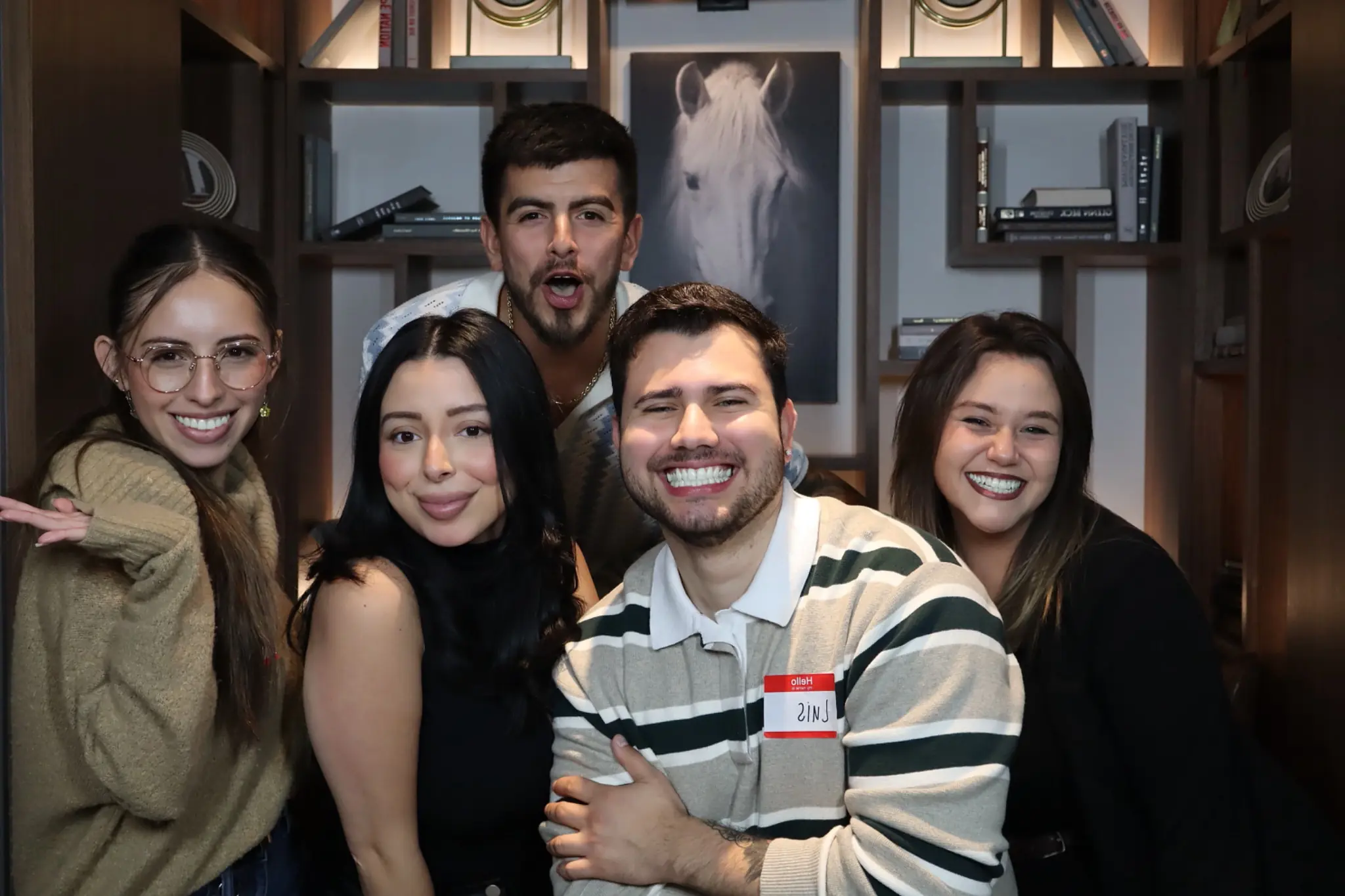 Corporate mixer guests sharing a lively photo booth moment by Images & Creations